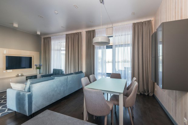 Elegant living and dining space featuring contemporary furnishings and natural light.
